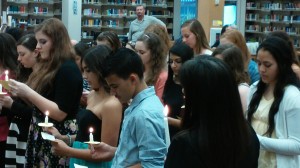 Inductees hold ceremonial candles, which were lit my the mother candle is kept, while reciting the Spanish Honor Society oath. The mother candle is kept for the duration of the clubs existence, always lighting the smaller candles at the induction.